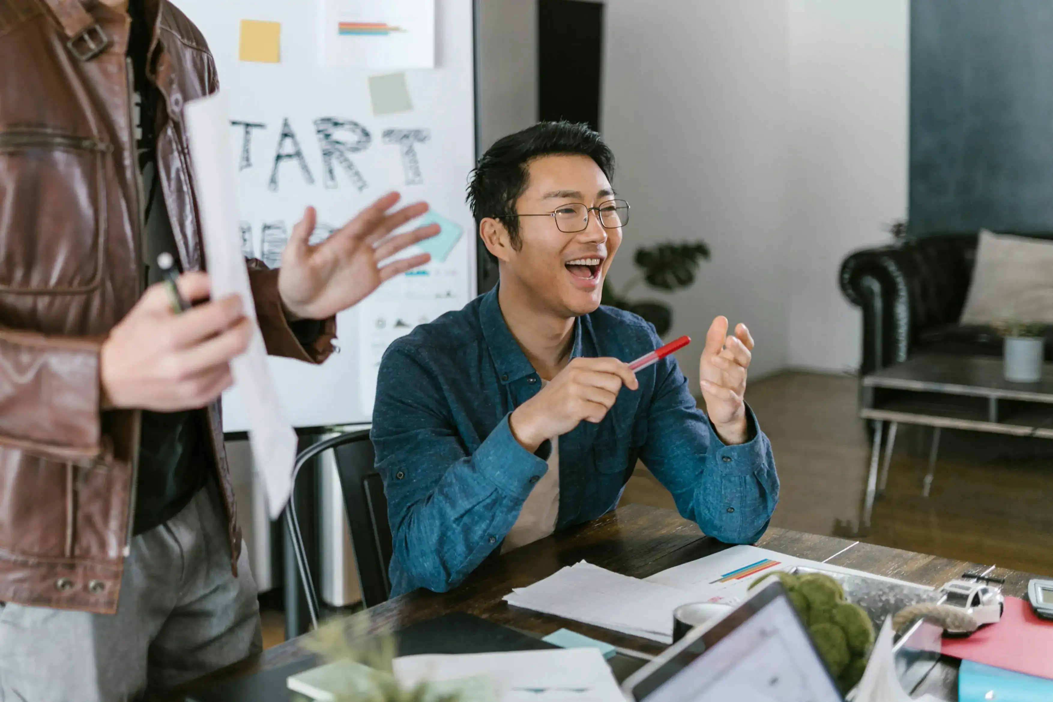A smiling team member discussing ideas during a creative meeting.