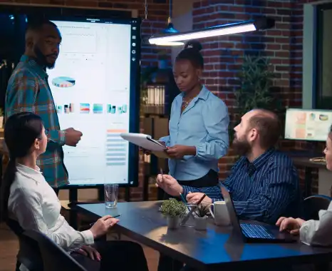 Team discussing a digital report during a meeting..